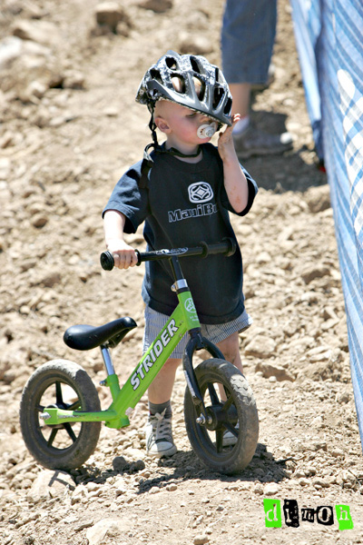 Future cyclist cleaning himself off after hitting the deck.